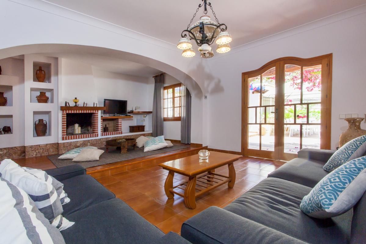 Bright and spacious living room with sofas and fireplace